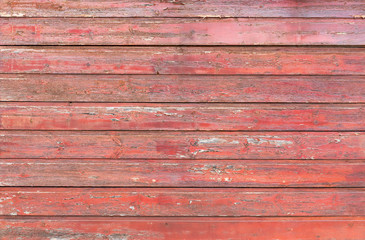 Old wooden planks painted red as a natural background or texture.