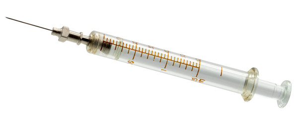 Old glass medical syringe isolated on a white background