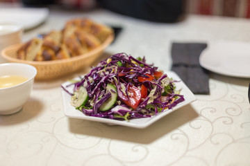 cabbage-based vegetable salad on a table in a restaurant