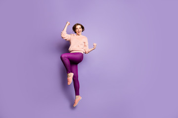 Full body profile photo of pretty funky lady jumping up high excited mood celebrating sports...