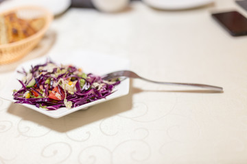 Obraz na płótnie Canvas cabbage-based vegetable salad on a table in a restaurant