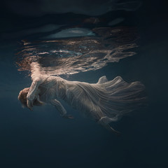 Woman in a sequin dress underwater