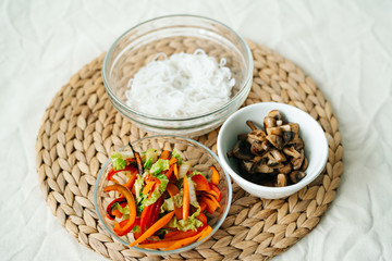 Japanese ramen soup with vegan ingredients, fresh vegetables, rice noodles, mushrooms and miso paste broth, vegan dish