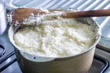 Ghomi, popular dish made of white coarse cornmeal, in big kettle.