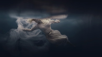 Woman in a sequin dress underwater