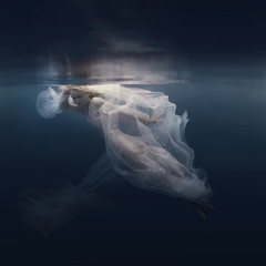 Woman in a sequin dress underwater