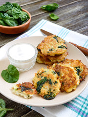 Pancakes with cabbage and spinach. Juicy vegetable cutlets on a plate with sour cream. Diet menu. Lenten dish.