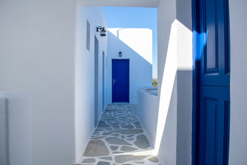 Photo shows a classic complex of Cycladic rooms to let,painted white with blue doors.Holidays concept.