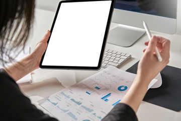 Mockup mobile tablet template with white screen used by a caucasian business woman 