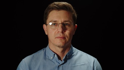 Fototapeta premium Portrait of Young Adult Man In Glasses on black background