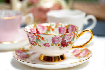 Ornamental tea cup with rose pattern