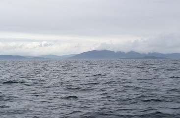 The moody seascape of the North Atlantic ocean in a foggy summer day. The shot has been taken from a little ferry boat that took me from Mull island to the liytle and wild Staffa island in Scotland