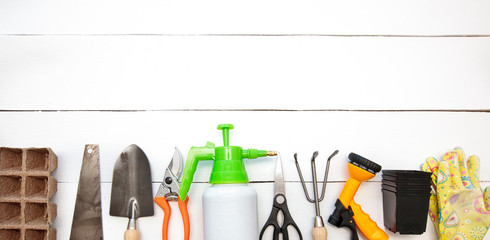 A lot of different garden equipment on the wooden table