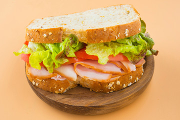 Sandwich of tomato, lettuce and smoked turkey