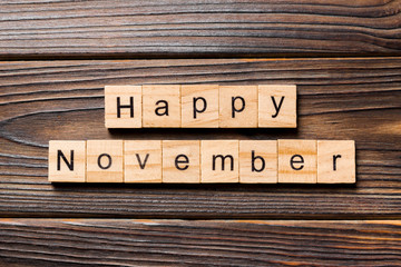 Happy november word written on wood block. Happy november text on table, concept