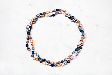 necklace from colored river pearls on gray