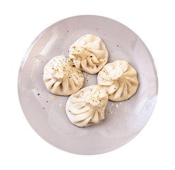 top view of cooked khinkali on gray plate isolated