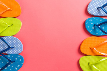 a lot of flip flop colored sandals, summer vacation on colored background, copy space top view