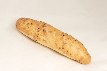 Long loaf with onions and cheese, assortment of bread and bakery products. Closeup on a light background