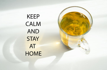 Keep calm and stay at home. Self isolation and quarantine campaign to protect yourself and save lives. Herbal tea, shadow and sun rays. - Image