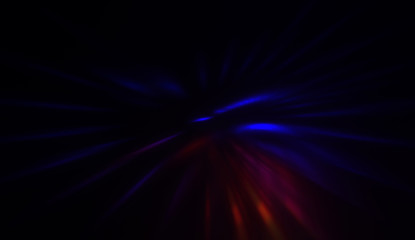 Light particles in motion, creating a burst of glowing multicolored rays on a black background. Energetic glow lights wallpaper.