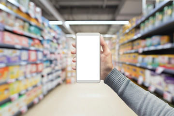 Female hand holding mobile smart phone on Supermarket blur background, business concept