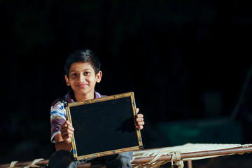Young indian cute child showing slate