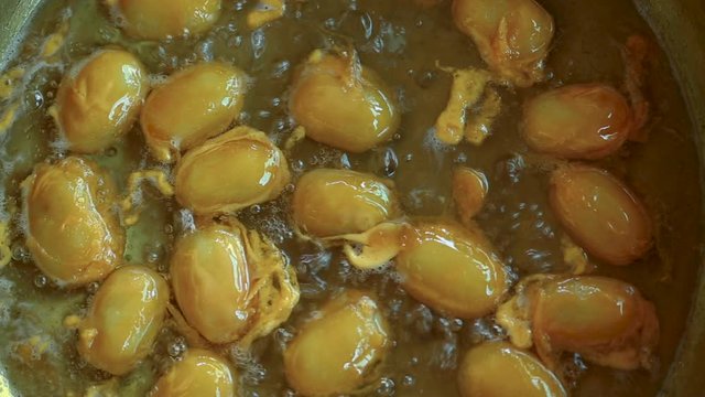 How to made thai dessert, close up fo Bean paste or Med Kanoon boiling in syrup in bronze pan.The most famous of Thai dessert. 