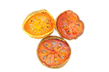Dried bael fruit slices isolate on white background.