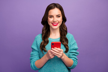 Photo of pretty lady hold telephone writing new post youth popular blog browsing multimedia documents wear blue knitted pullover isolated purple color background