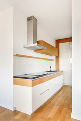 Fototapeta na wymiar Narrow kitchen with wooden elements