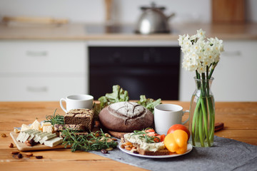 Delicious and healthy Breakfast. Bread, cheese and sweet peppers on the table is the best meal for a vegan. Dinner in the kitchen with flowers. Cooking at home.