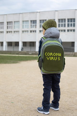 A school boy in front of the empty school during coronavirus quarantine.