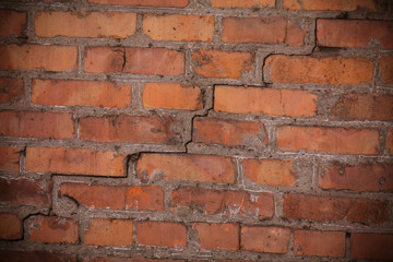 A crack in a brick wall. Old red brick wall