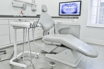 Dental chair and modern tools in light office