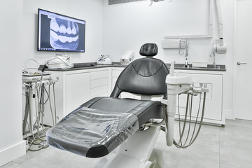 Dentist office with chair and computer monitor