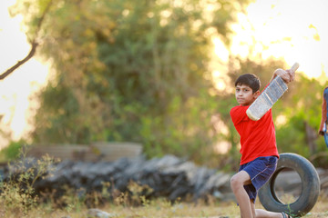 Rural Indian Child Playing Cricket