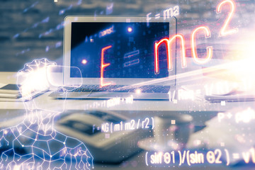 Desktop computer background and formula hologram writing. Double exposure. Education concept.