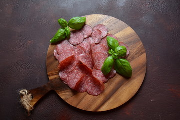 Sliced salami on cutting board
