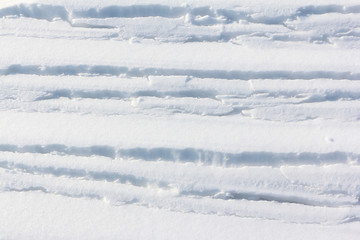Fototapeta na wymiar Cracks on the snowy surface of the river