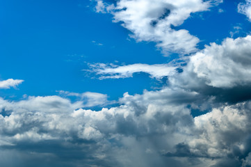 Gray white clouds. Clouds of thunderclouds on a blue sky. Summer day. Beautiful nature background