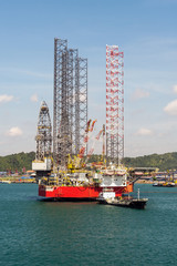 Jack-up drilling rig supporting oil and gas industry anhored inside port limit