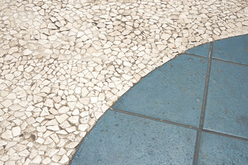 Pebble pattern floor on outdoor park with blue tile