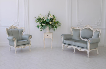Gray sofa and armchair in a white room