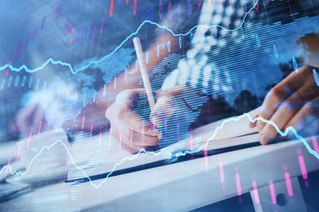Multi exposure of two men planing investment with stock market forex chart.