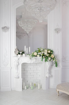 White Fireplace With Mirror And Crystal Chandelier