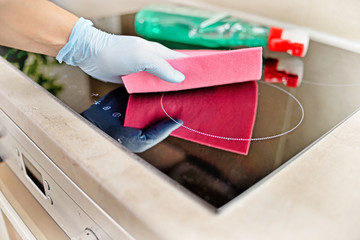 Woman in gloves cleaning kitchen.	 - obrazy, fototapety, plakaty