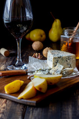 Cheese platter with blue cheese and pear. Wine snack. Italian cuisine. Vegetarian food. Healthy eating.