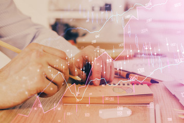 Multi exposure closeup hands with stock market forex graph.