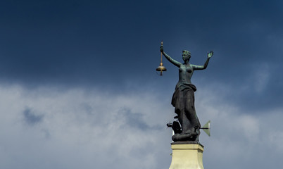 April 27, 2018 Vilnius, Lithuania. Statue of a woman with a lantern and a raised hand at the building of a former power station in Vilnius.